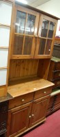 Lot 1253 - A modern pine dresser, having twin door glazed...