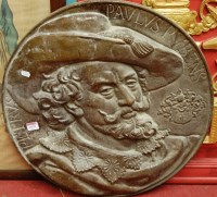 Lot 1078 - A reproduction bronzed metal plaque of Peter...