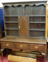 Lot 1104 - An early 20th century oak dresser, in the...