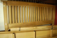 Lot 1121 - A contemporary light oak slatback kingsize...