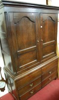 Lot 1122 - A George III oak double door housekeepers...