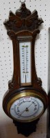 Lot 1125 - A mid-20th century carved oak two dial aneroid...