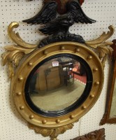 Lot 1130 - A late 19th century gilt wood convex wall...