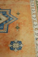 Lot 1167 - A Caucasian woollen peach ground carpet having...