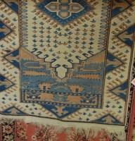 Lot 1172 - A Caucasian woollen cream ground rug, together...