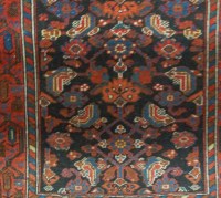 Lot 1173 - A Persian woollen blue ground rug (worn)...