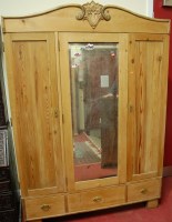 Lot 1176 - A French pine three door armoire having...