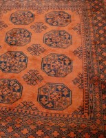 Lot 1181 - A Persian woollen bokhara rug having a rust...