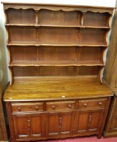 Lot 1183 - A contemporary Ercol dark elm dresser, having...