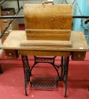 Lot 1198 - A Singer treadle sewing machine, together with...