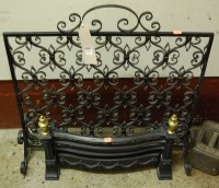 Lot 1151 - A black painted wrought iron fire screen,...