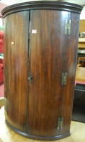 Lot 1326 - An early 19th century mahogany bowfront double...