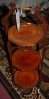 Lot 1337 - A 1930s walnut octagonal three tier folding...