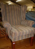Lot 1340 - A contemporary striped upholstered wingback...