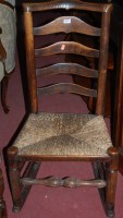 Lot 1352 - A circa 1900 elm and oak rush seat ladder back...
