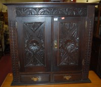 Lot 1383 - A low relief floral carved oak double door...