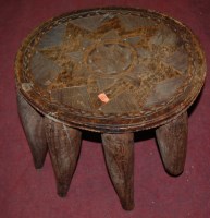 Lot 1391 - An African hardwood low relief carved circular...