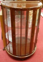 Lot 1200 - A 1930s figured walnut bow front single door...