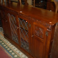 Lot 1427 - A contemporary moulded oak four door side...