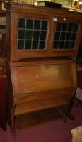 Lot 1263 - An Arts & Crafts oak and coloured lead glazed...