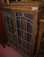 Lot 1432 - A 1930s oak ledgeback double door lead glazed...