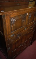 Lot 1434 - A contemporary moulded oak drinks cabinet,...