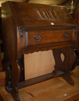 Lot 1445 - A Continental moulded oak slopefront writing...