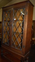 Lot 1325 - A moulded oak ledgeback double door lead...