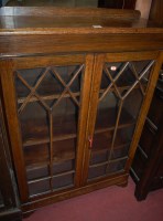 Lot 1431 - A 1930s oak ledge back double door glazed...
