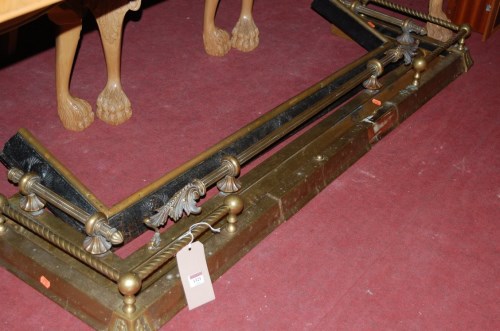 Lot 1321 - Two Edwardian brass kerb fenders; together...