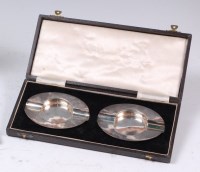 Lot 82 - A pair of mid-20th century silver ashtrays,...