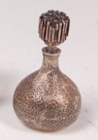 Lot 87 - A 1970s silver perfume bottle, having relief...