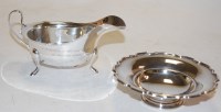 Lot 282 - A modern silver sauceboat by Viners, together...