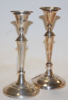 Lot 286 - A pair of Edwardian silver table candlesticks...