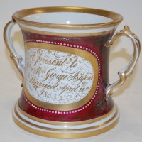 Lot 12 - A 19th century loving cup, the central panel...