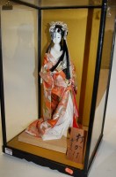 Lot 25 - A modern figure of a geisha girl, in glazed...