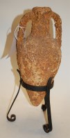Lot 50 - An early amphora twin handled vase on an iron...