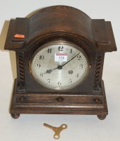 Lot 124 - A 1920s oak cased mantel clock, having a...