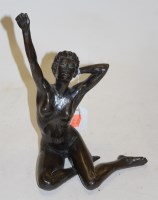 Lot 57 - A bronzed resin figure of a seated female nude