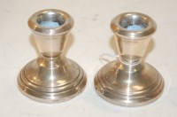 Lot 353 - A pair of silver dwarf candlesticks on loaded...
