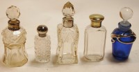 Lot 411 - Three various cut glass silver topped scent...