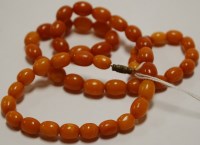 Lot 429 - A beaded butterscotch amber single string...