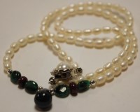 Lot 434 - A small cultured pearl necklace, set with four...