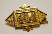 Lot 447 - A yellow metal Egyptian Revival brooch, having...