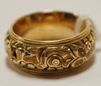 Lot 455 - A chased yellow metal wedding band, unmarked...