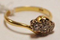 Lot 479 - A ladies 18ct gold diamond crossover ring, the...