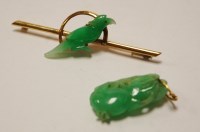Lot 499 - A Chinese carved green jade pendant, 2.8cm;...