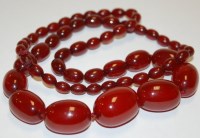 Lot 507 - A beaded cherry amber necklace, the largest...
