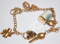 Lot 510 - A modern ladies 9ct gold charm bracelet, gross...