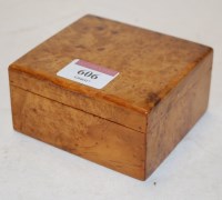 Lot 606 - An early 20th century burr yew table cigarette...